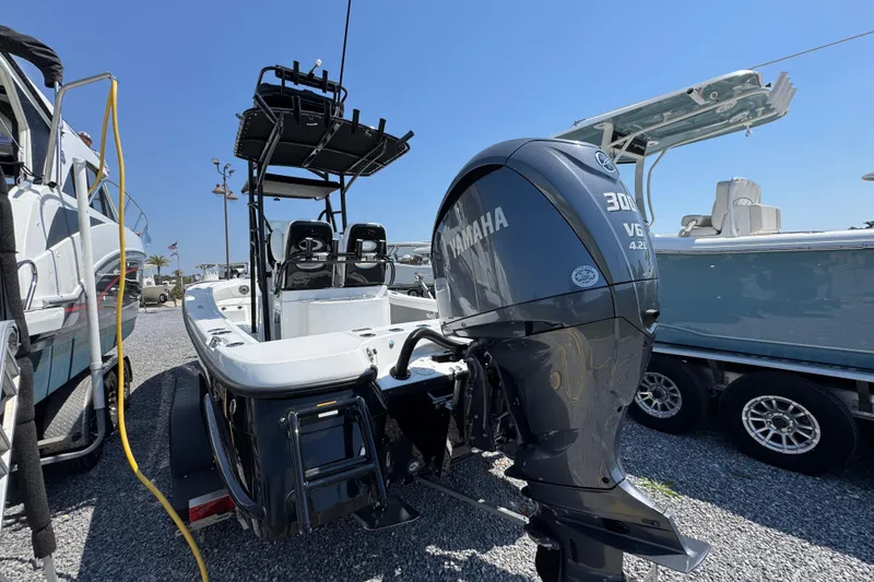 Slide: The Image of 2025 BlackJack 256 Coastal boat with Yamaha 300 V6 engine, parked on gravel. - 10