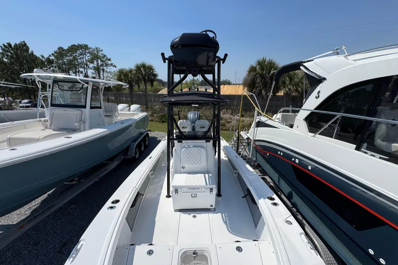 Slide: The Image of 2025 BlackJack 256 Coastal boat displayed in a marina, surrounded by other vessels. - 17