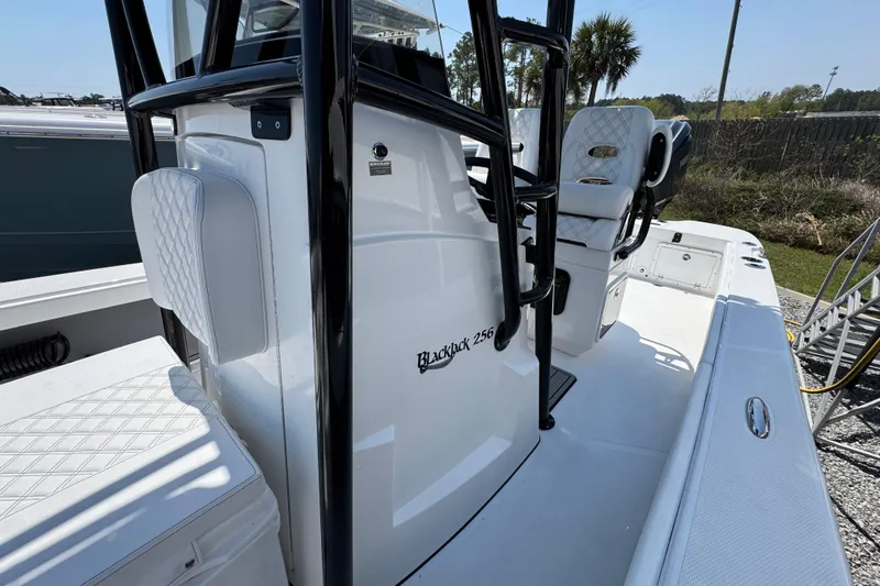 Slide: The Image of 2025 BlackJack 256 Coastal boat interior with seating and console details. - 19
