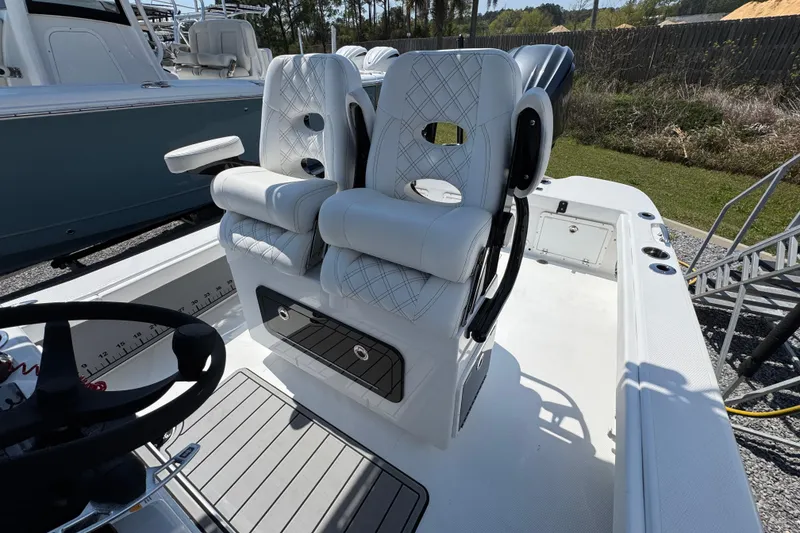 Slide: The Image of 2025 BlackJack 256 Coastal boat interior with luxurious white seating and modern steering wheel. - 21