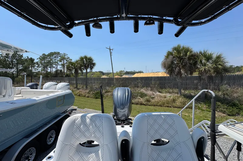 Slide: The Image of 2025 BlackJack 256 Coastal boat interior with dual seats and outboard motor. - 23