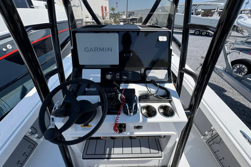 Slide: The Image of 2025 BlackJack 256 Coastal boat console with Garmin navigation system and steering wheel. - 26