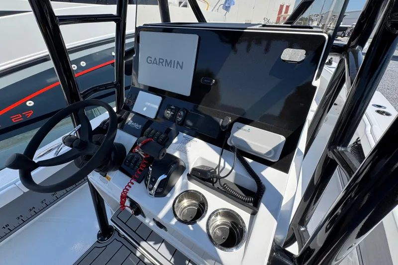 Slide: The Image of Center console of a 2025 BlackJack 256 Coastal boat featuring Garmin electronics. - 28