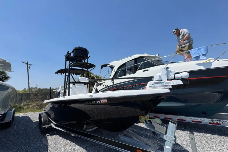 Slide: The Image of 2025 BlackJack 256 Coastal boat on trailer, clear sky background. - 3