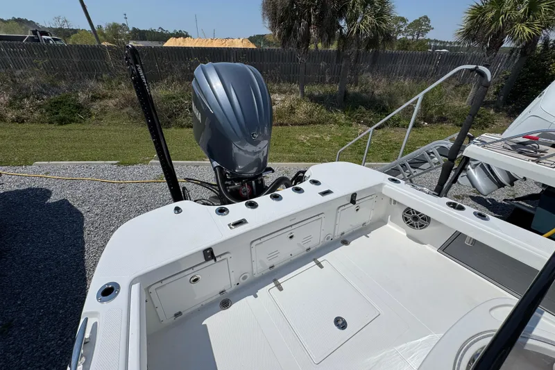 Slide: The Image of 2025 BlackJack 256 Coastal boat with Yamaha outboard motor, docked outdoors. - 33