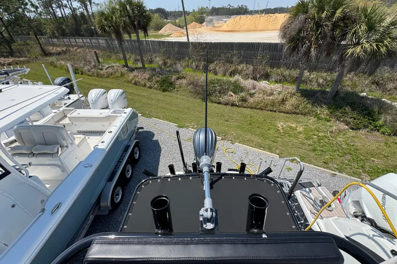 Slide: The Image of Aerial view of 2025 BlackJack 256 Coastal boat on trailer, surrounded by greenery. - 38