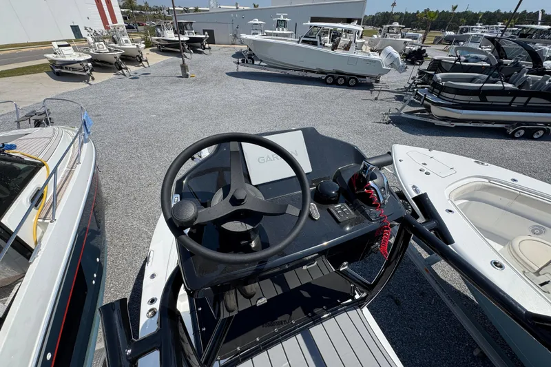Slide: The Image of Steering console of a 2025 BlackJack 256 Coastal boat in a marina. - 39