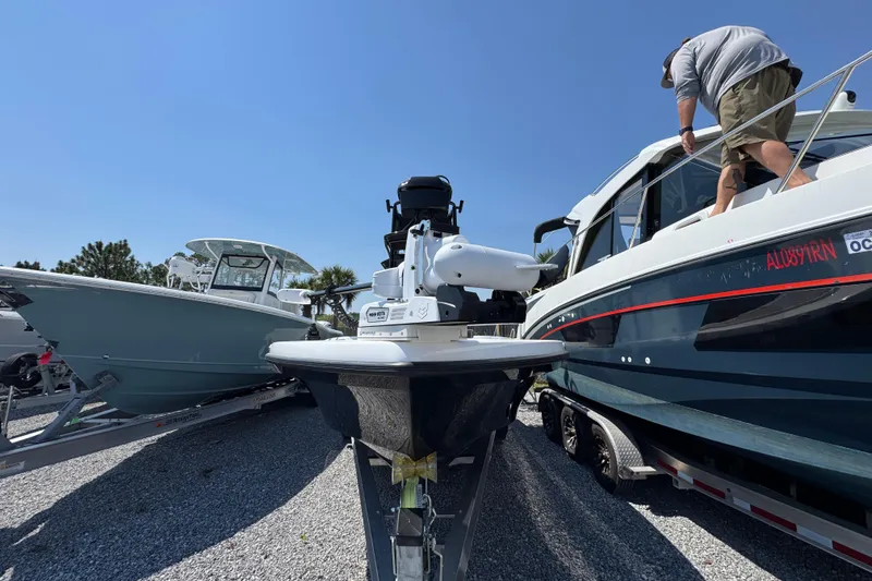 Slide: The Image of 2025 BlackJack 256 Coastal boat on trailer, parked beside another vessel under clear blue sky. - 5