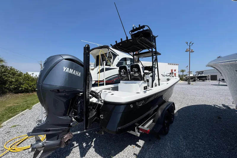 Slide: The Image of 2025 BlackJack 256 Coastal boat with Yamaha engine, parked on gravel lot. - 7
