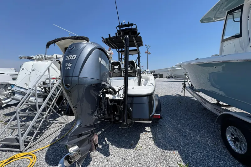 Slide: The Image of 2025 BlackJack 256 Coastal boat with Yamaha 300 V6 engine, parked on gravel. - 8