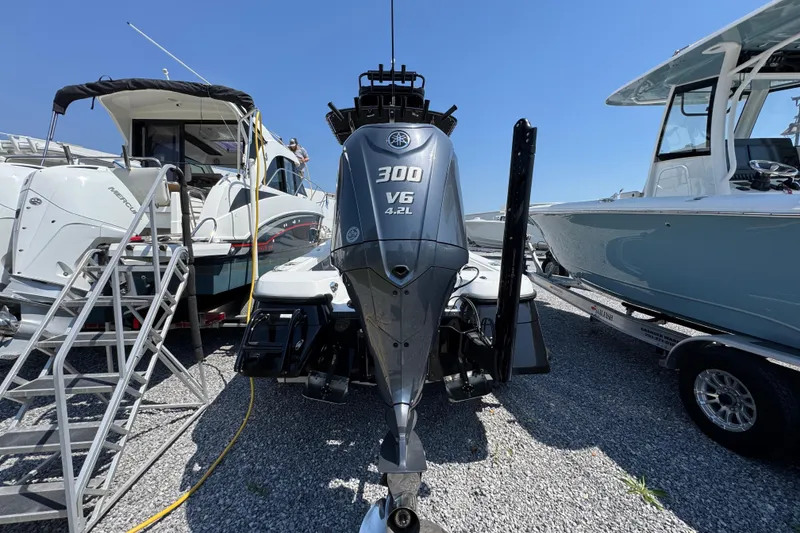 Slide: The Image of 2025 BlackJack 256 Coastal boat with Yamaha 300 V6 engine, displayed outdoors. - 9