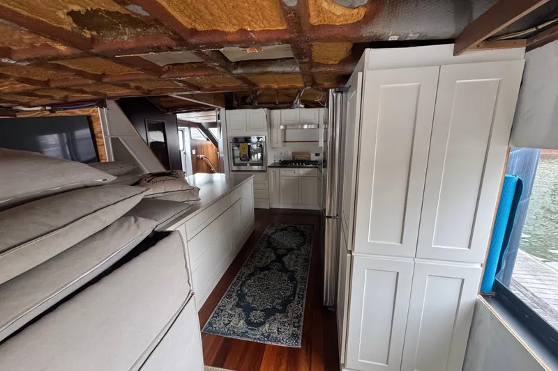 Slide: The Image of Luxurious kitchen interior of 1997 Tarrab 77 Motor Yacht with modern appliances and waterfront view. - 12