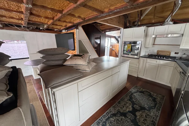 Slide: The Image of Spacious kitchen interior on 1997 Tarrab 77 Motor Yacht with modern appliances and island. - 13