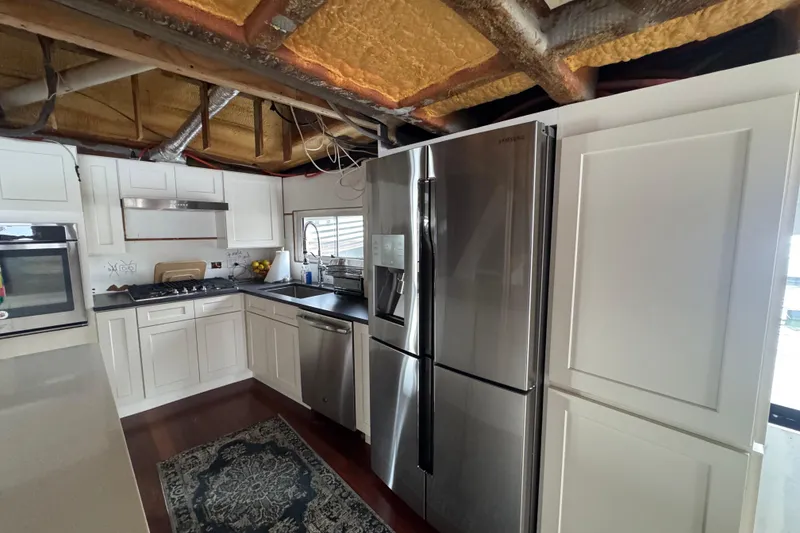 Slide: The Image of Modern kitchen in a 1997 Tarrab 77 Motor Yacht with stainless steel appliances. - 14