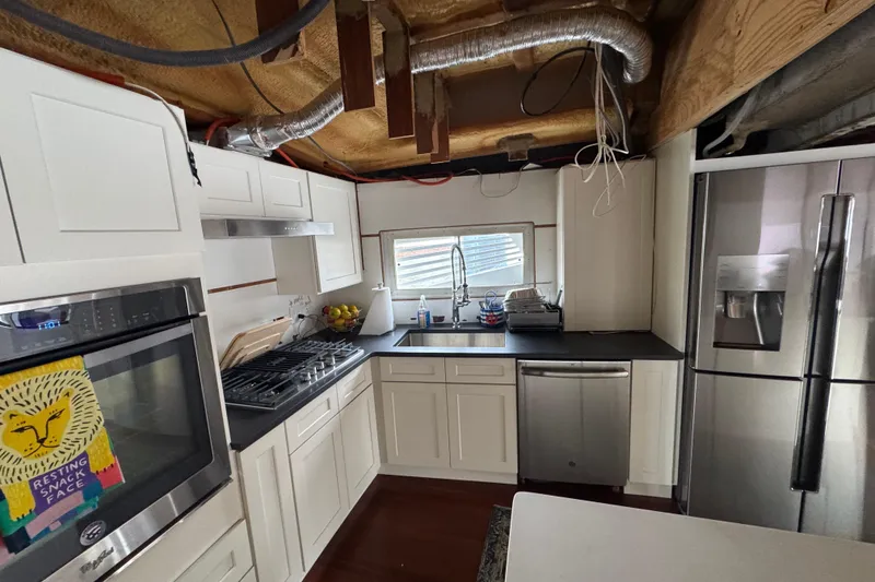 Slide: The Image of Interior of 1997 Tarrab 77 Motor Yacht featuring modern kitchen and helm area. - 16