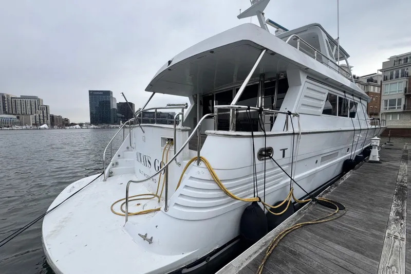 Slide: The Image of Tarrab 77 Motor Yacht, 1997 model, docked at a marina with cityscape background. - 2