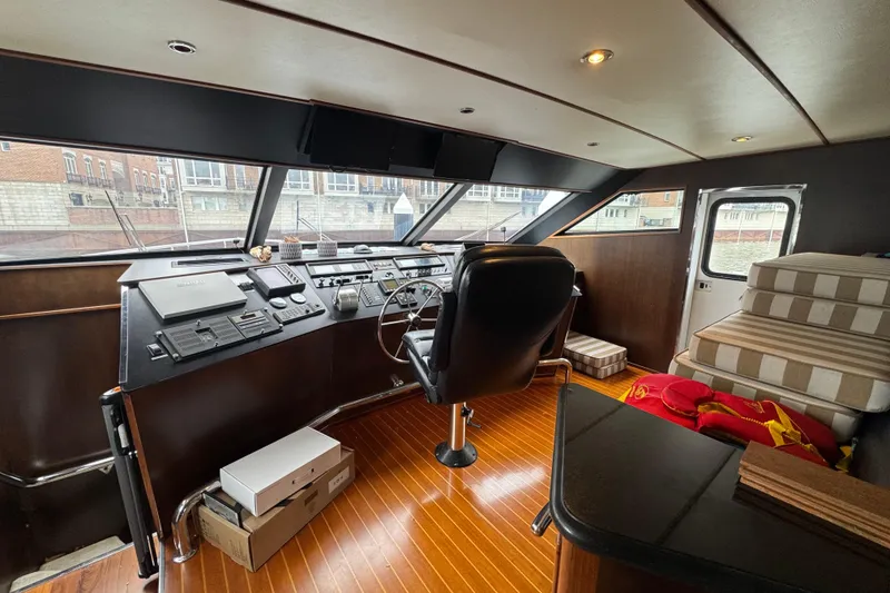 Slide: The Image of Interior helm of 1997 Tarrab 77 Motor Yacht with control panels and captain's chair. - 21
