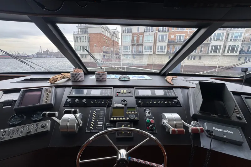 Slide: The Image of Control panel of a 1997 Tarrab 77 Motor Yacht, near a window with a waterfront view. - 26