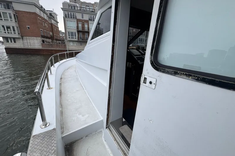 Slide: The Image of 1997 Tarrab 77 Motor Yacht on urban waterfront with city skyline. - 28