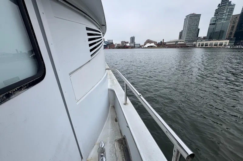 Slide: The Image of Bow view of 1997 Tarrab 77 Motor Yacht near waterfront buildings. - 29