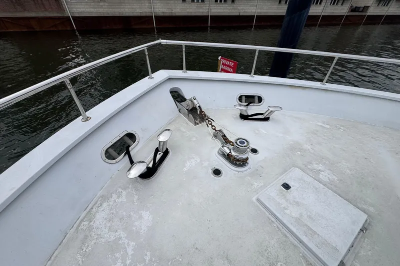 Slide: The Image of 1997 Tarrab 77 Motor Yacht docked near waterfront buildings on a cloudy day. - 31