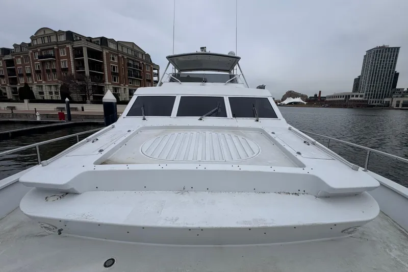 Slide: The Image of Tarrab 77 Motor Yacht, 1997 model, docked in an urban marina setting. - 32