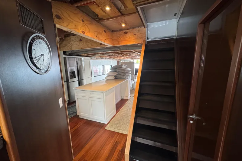 Slide: The Image of Stairway view inside 1997 Tarrab 77 Motor Yacht, showcasing sleek interior design. - 34