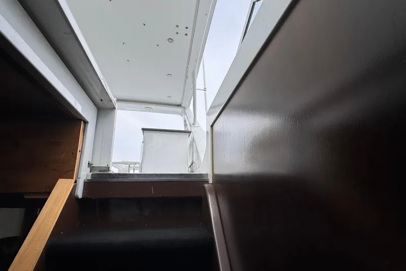 Slide: The Image of Cockpit of a 1997 Tarrab 77 Motor Yacht with waterfront view and modern controls. - 35