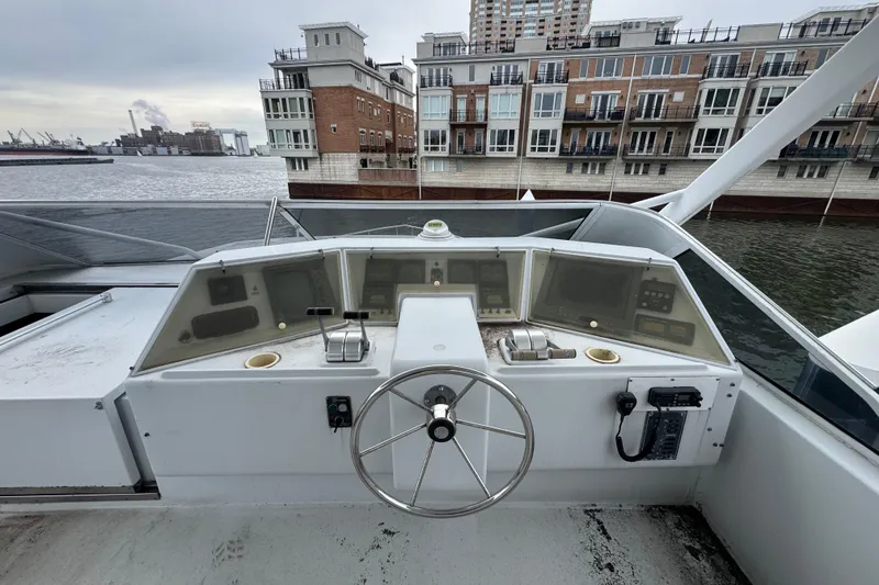 Slide: The Image of Bow view of 1997 Tarrab 77 Motor Yacht docked near waterfront buildings. - 37