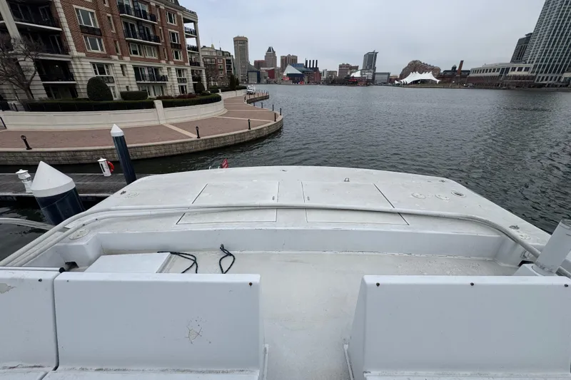 Slide: The Image of Tarrab 77 Motor Yacht 1997, docked near waterfront buildings, overcast sky. - 42