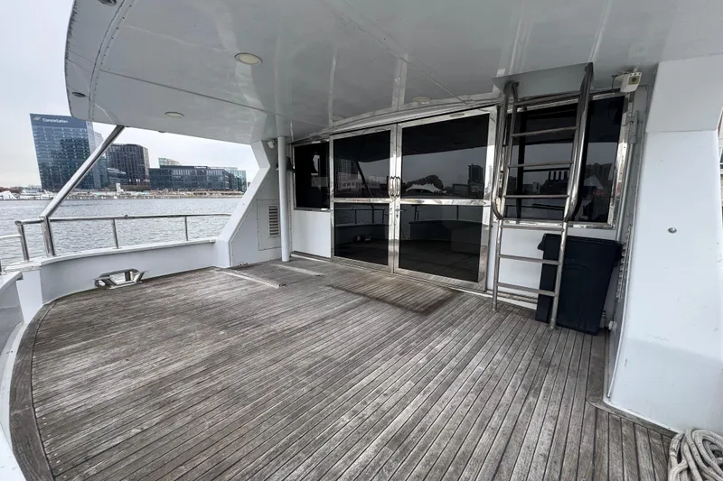 Slide: The Image of Spacious deck of 1997 Tarrab 77 Motor Yacht with waterfront view. - 5