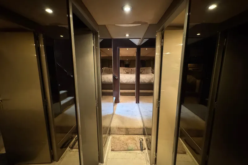 Slide: The Image of Storage area inside a 1997 Tarrab 77 Motor Yacht, featuring various supplies and wooden walls. - 53