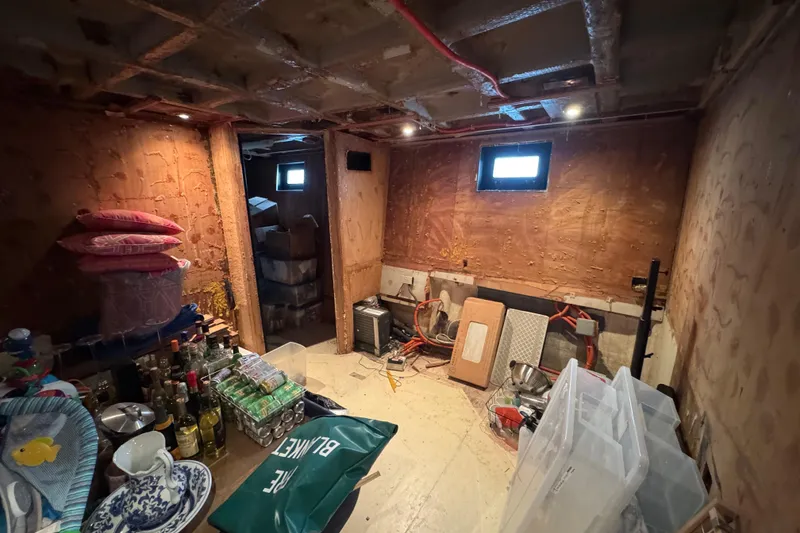 Slide: The Image of Dimly lit storage room with boxes and equipment, aboard a 1997 Tarrab 77 Motor Yacht. - 57