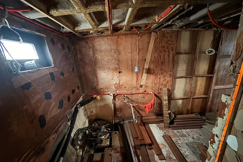 Slide: The Image of Interior of 1997 Tarrab 77 Motor Yacht under renovation, showing exposed framework and wiring. - 59