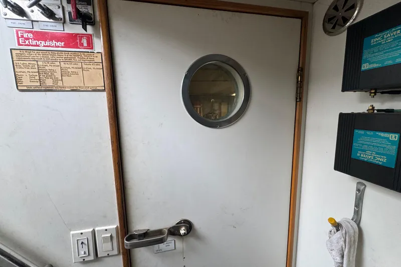 Slide: The Image of Engine room of a 1997 Tarrab 77 Motor Yacht, featuring dual engines and equipment. - 64