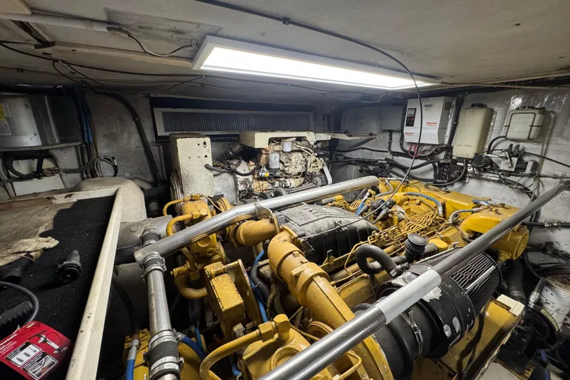Slide: The Image of Engine room of a 1997 Tarrab 77 Motor Yacht, showcasing complex machinery and components. - 66