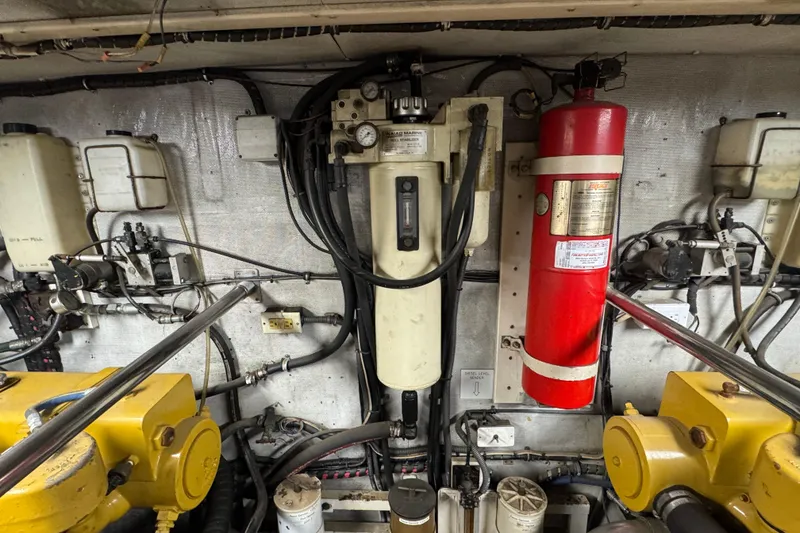 Slide: The Image of Engine room of a 1997 Tarrab 77 Motor Yacht, showcasing mechanical components and wiring. - 70