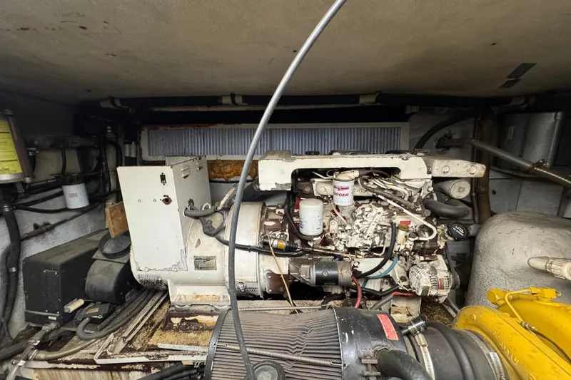 Slide: The Image of Engine room of a 1997 Tarrab 77 Motor Yacht, featuring complex machinery and gauges. - 71