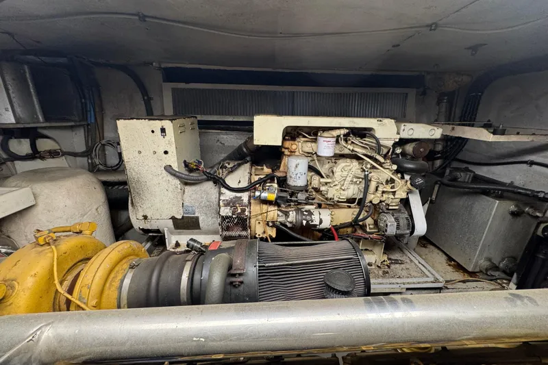 Slide: The Image of Engine room of a 1997 Tarrab 77 Motor Yacht, showcasing mechanical components and wiring. - 73