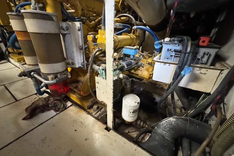 Slide: The Image of Engine room of a 1997 Tarrab 77 Motor Yacht, showcasing mechanical components and wiring. - 75