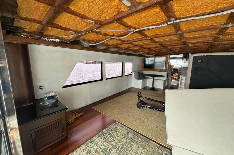 Slide: The Image of Luxurious interior of a 1997 Tarrab 77 Motor Yacht with spacious seating and modern kitchen. - 9