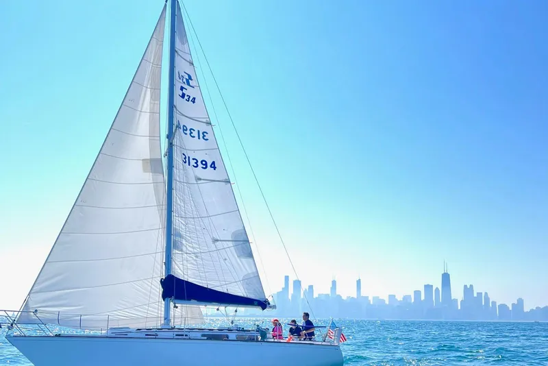 The Image of 1982 Sabre 34 sailboat cruising on blue waters with city skyline in background. - 0