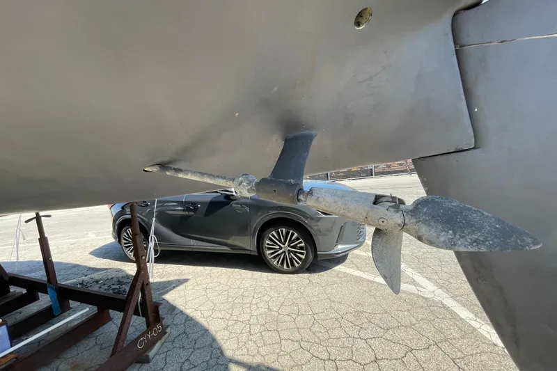 Slide: The Image of Propeller of a 1982 Sabre 34 sailboat with a car in the background. - 10