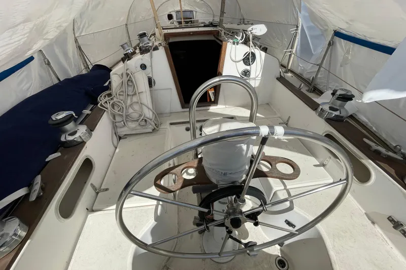 Slide: The Image of Steering wheel of a 1982 Sabre 34 sailboat, featuring a classic nautical design. - 11