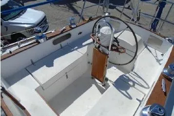 Slide: The Image of 1982 Sabre 34 sailboat cockpit with steering wheel and compass, showcasing classic design. - 12