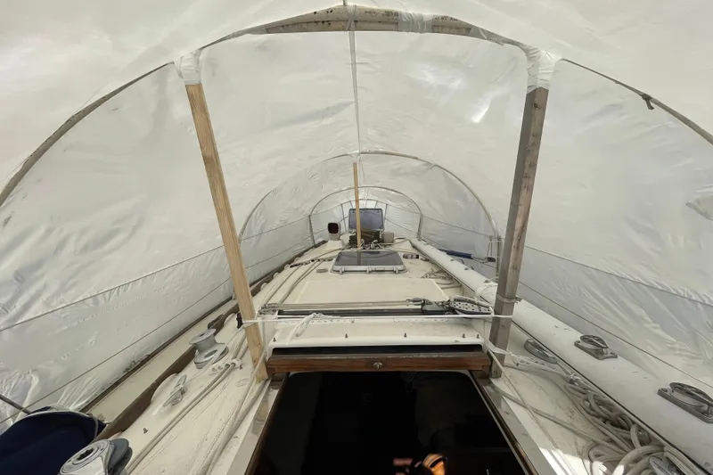 Slide: The Image of 1982 Sabre 34 sailboat deck with winches and ropes in a marina setting. - 14