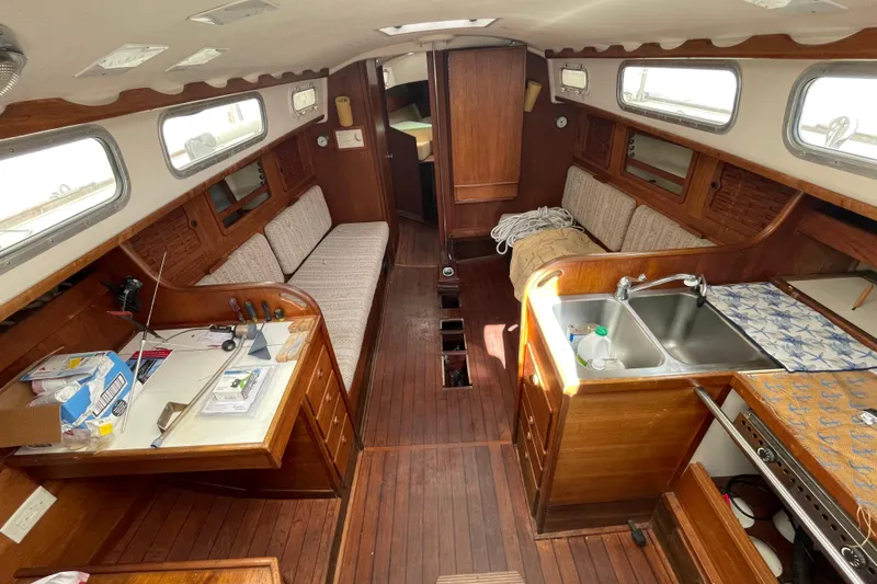 Slide: The Image of 1982 Sabre 34 sailboat deck in a parking area, showcasing rigging and fittings. - 16