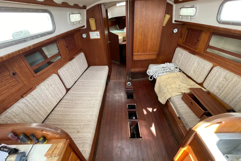 Slide: The Image of Interior of a 1982 Sabre 34 sailboat with wooden finishes and cozy seating. - 17