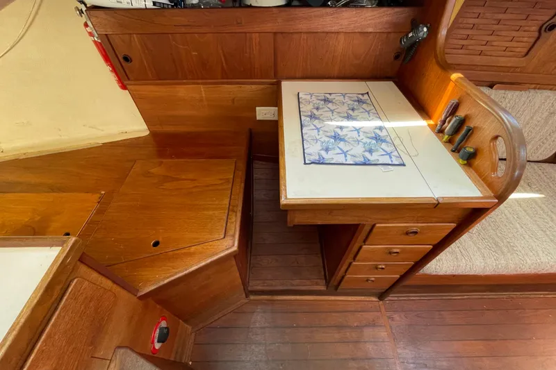 Slide: The Image of 1982 Sabre 34 sailboat interior with wooden cabinetry and a compact workspace. - 20