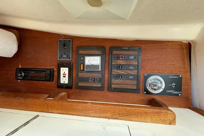 Slide: The Image of Control panel of a 1982 Sabre 34 sailboat with various switches and gauges. - 21